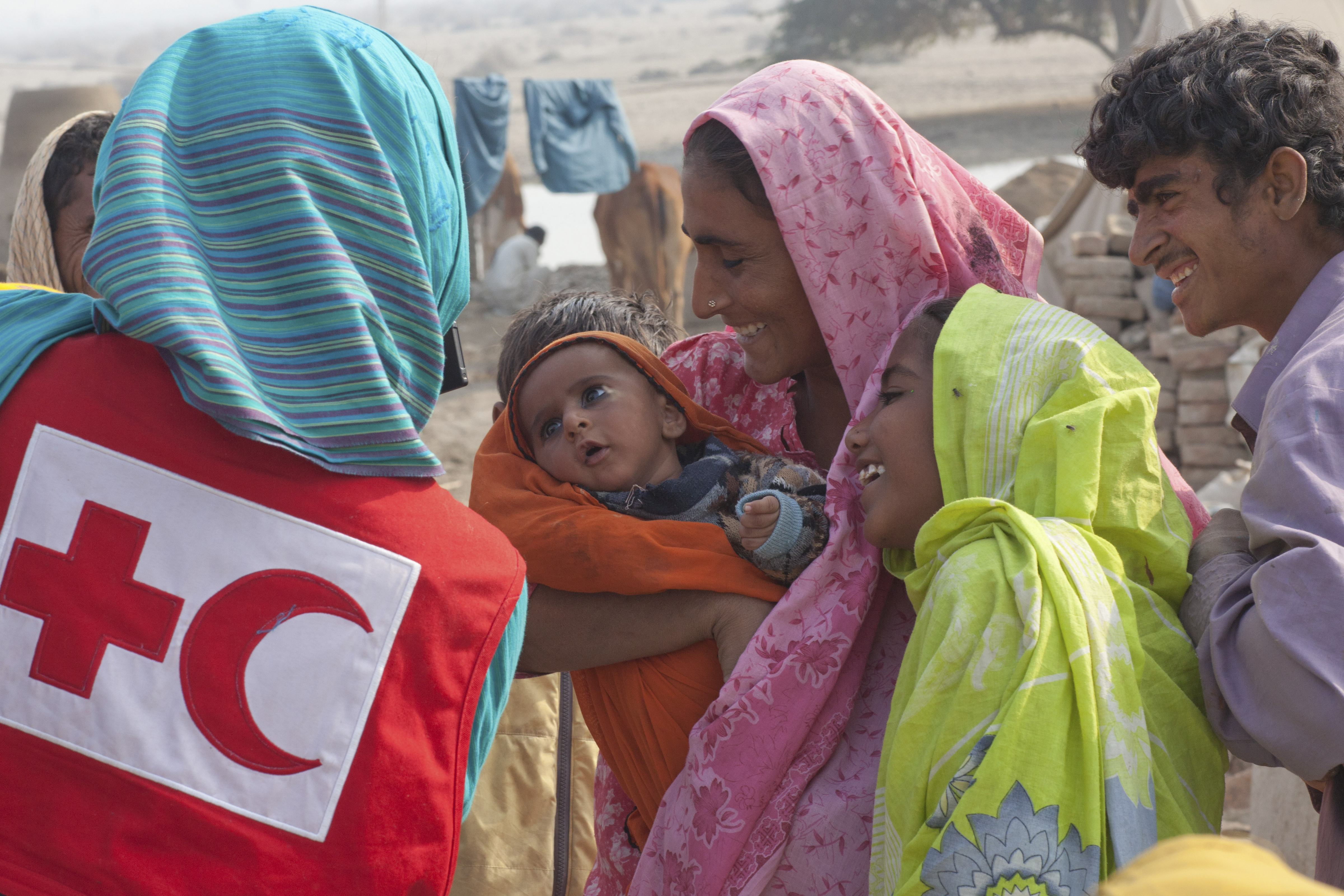 Une femme tient un enfant dans ses bras dans une région rurale du Pakistan.